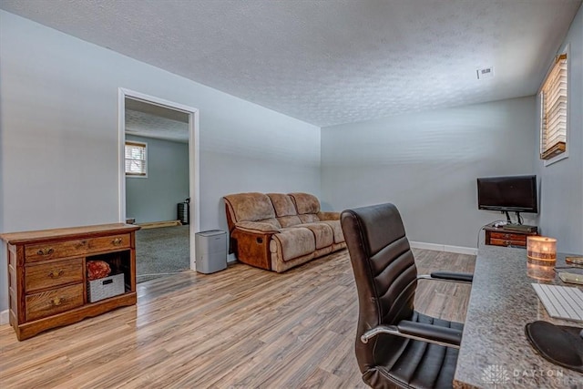 office space with hardwood / wood-style floors and a textured ceiling