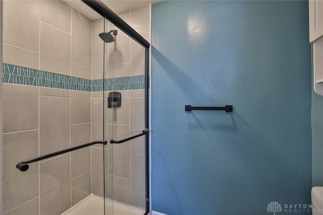 bathroom featuring walk in shower and toilet