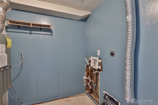 laundry room featuring hookup for an electric dryer and light tile patterned flooring