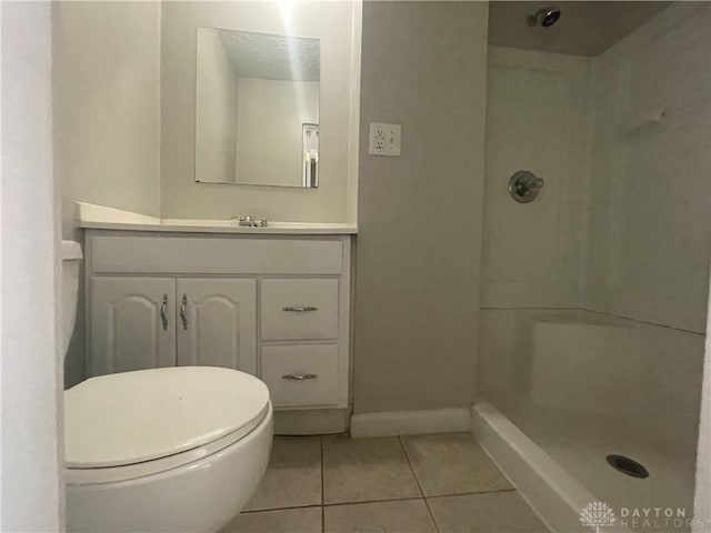 bathroom with walk in shower, tile patterned floors, toilet, and vanity