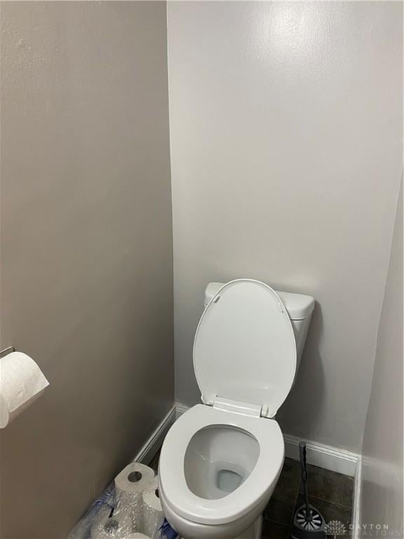 bathroom featuring toilet and tile patterned flooring