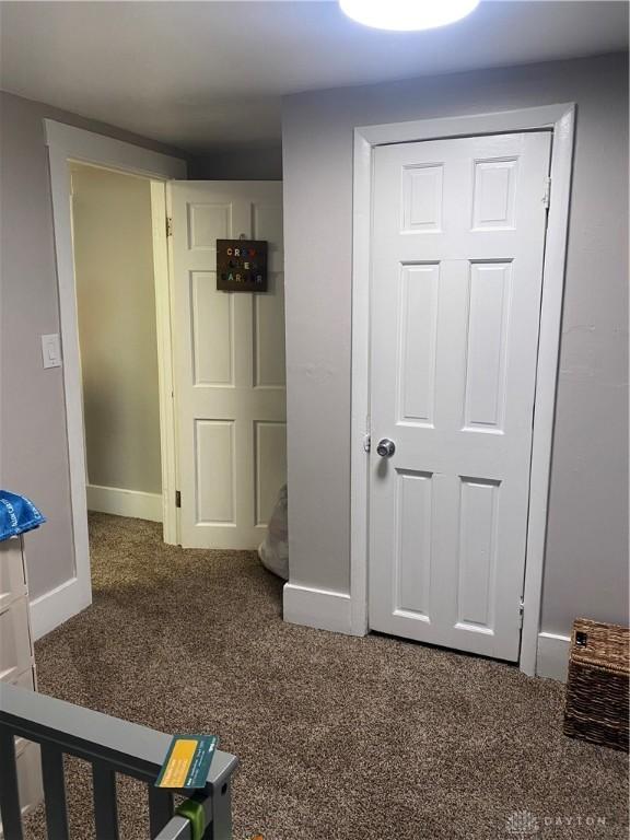 unfurnished bedroom featuring carpet floors and a closet