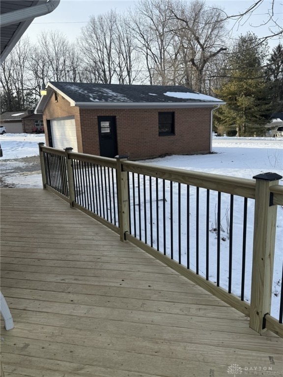 snow covered deck with a garage