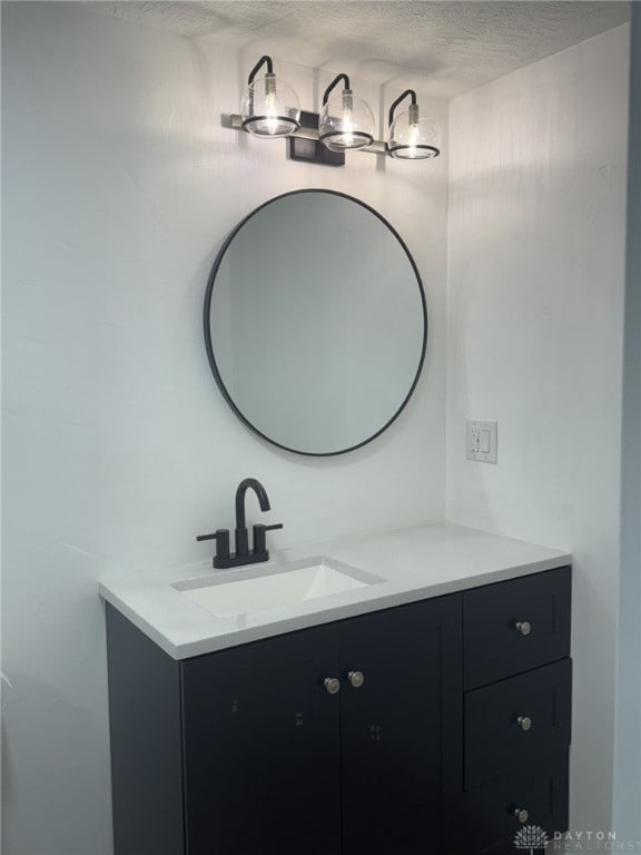 bathroom with vanity and a textured ceiling