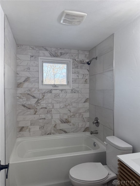 full bathroom featuring vanity, toilet, and tiled shower / bath