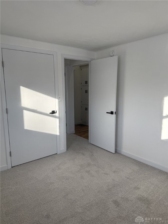 unfurnished room with a wealth of natural light and light colored carpet