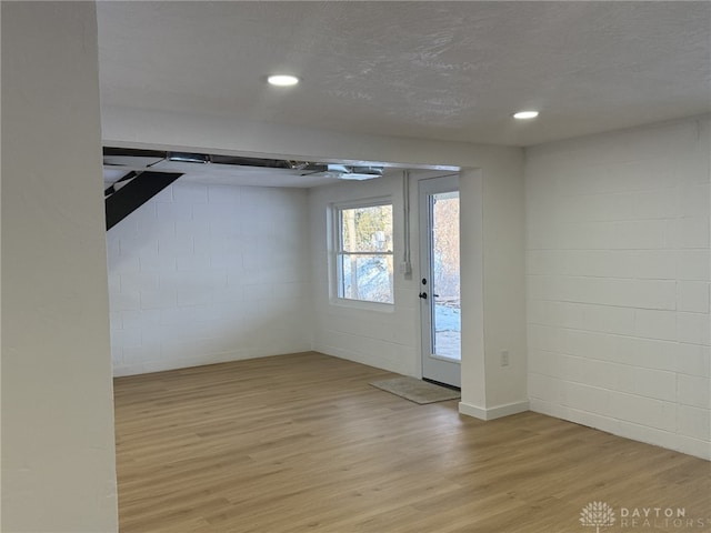 interior space with light hardwood / wood-style flooring and a textured ceiling