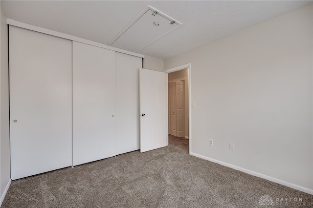 unfurnished bedroom featuring carpet floors and a closet