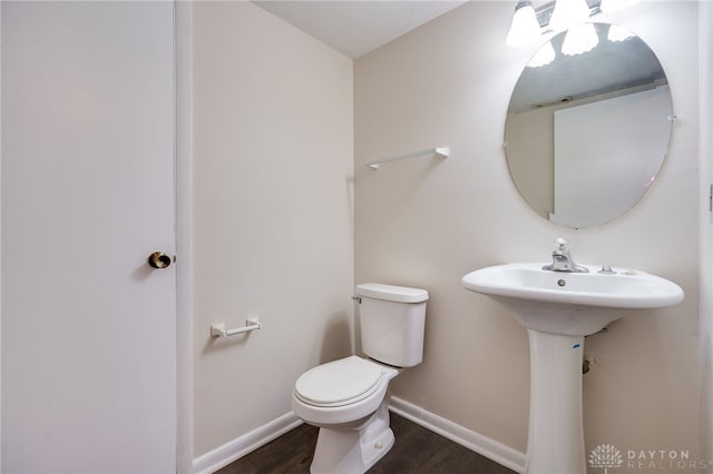 bathroom featuring hardwood / wood-style flooring and toilet