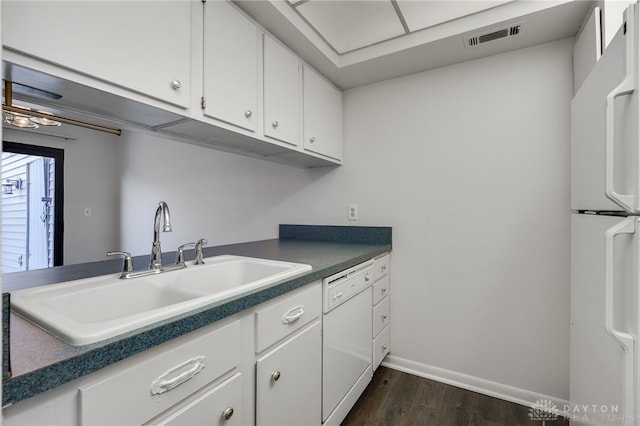 kitchen with white appliances, dark hardwood / wood-style flooring, sink, and white cabinets