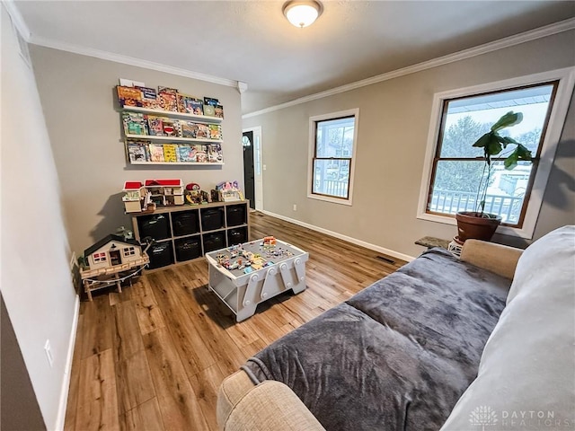 living room with crown molding and hardwood / wood-style flooring