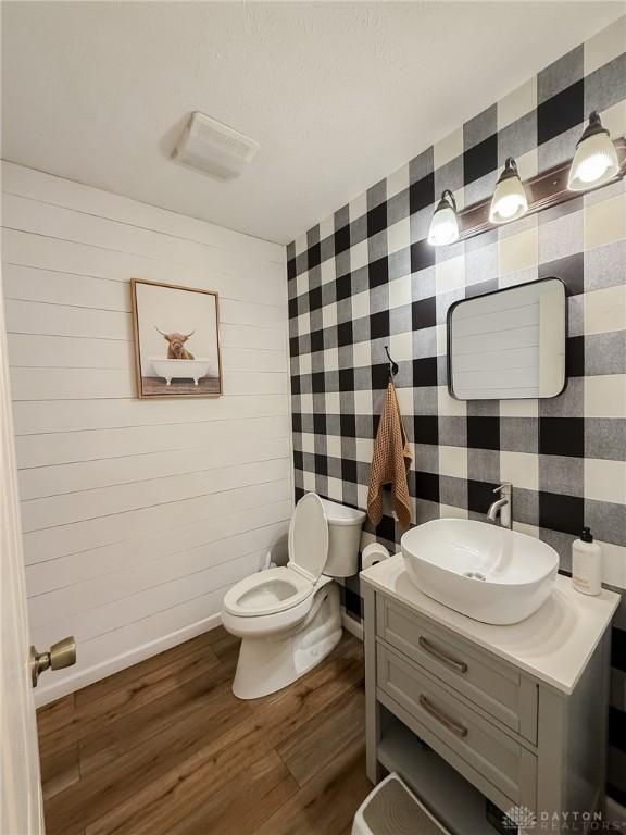 bathroom featuring vanity, hardwood / wood-style floors, and toilet