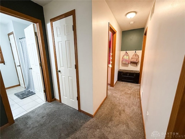 hallway with light colored carpet