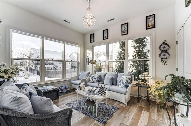 sunroom featuring a chandelier