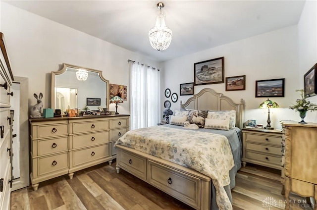 bedroom with hardwood / wood-style flooring and a chandelier