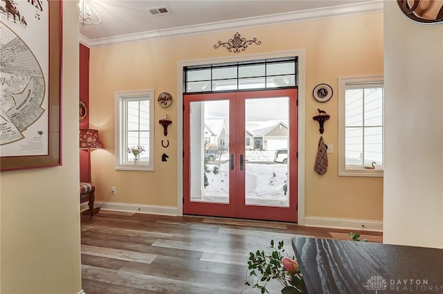 doorway featuring dark hardwood / wood-style flooring, crown molding, and french doors