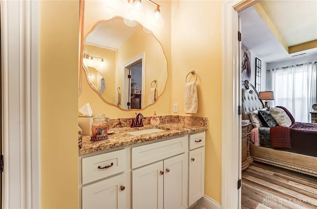 bathroom featuring hardwood / wood-style flooring and vanity