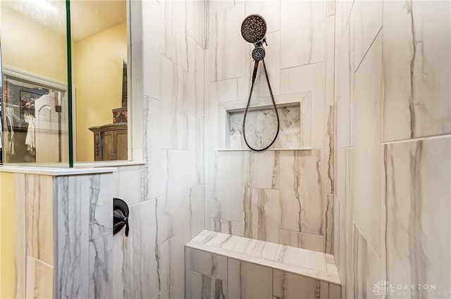 interior details featuring a tile shower