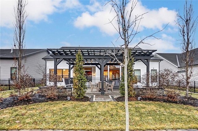 rear view of house with a yard, a pergola, and a patio area