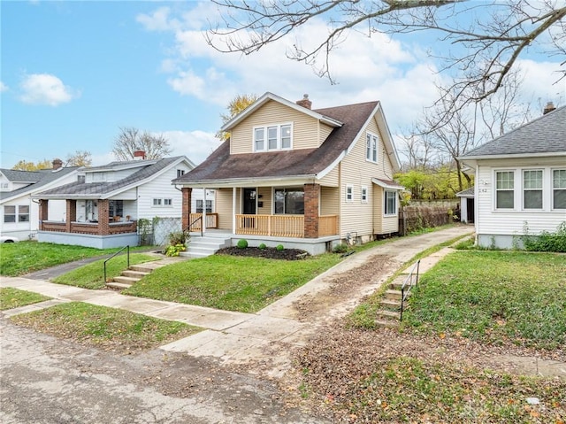 bungalow featuring a porch and a front lawn