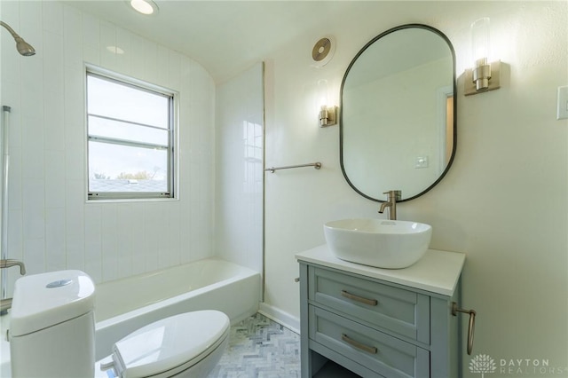 full bathroom with vanity, tiled shower / bath combo, and toilet