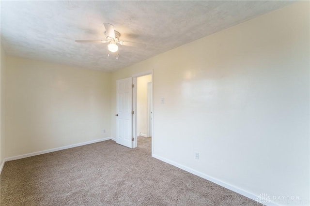 carpeted empty room with a textured ceiling and ceiling fan