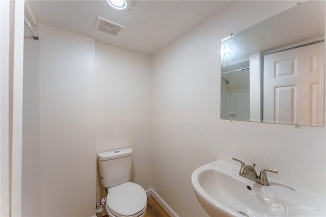 bathroom featuring sink, hardwood / wood-style floors, and toilet