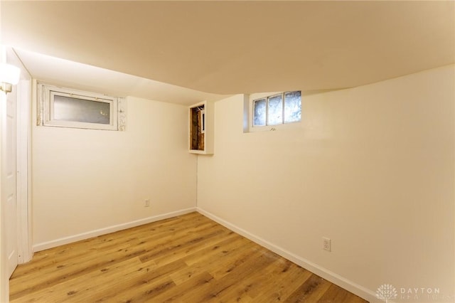 basement with light hardwood / wood-style flooring