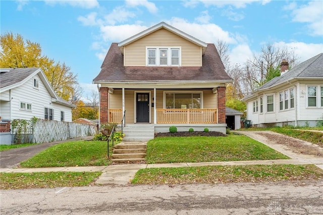 view of front of house with a porch and a front yard