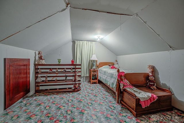 bedroom with lofted ceiling and carpet flooring