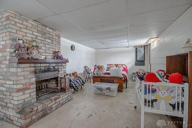 bedroom featuring a paneled ceiling, concrete flooring, electric panel, and a brick fireplace