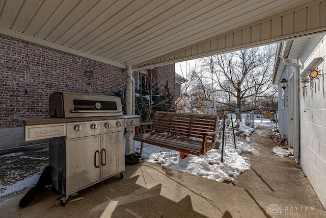 snow covered patio featuring grilling area