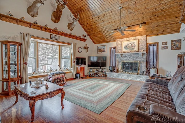 living room with high vaulted ceiling, hardwood / wood-style floors, a fireplace, and wood ceiling