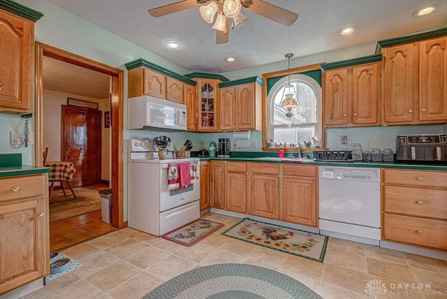 kitchen with ceiling fan, sink, white appliances, and decorative light fixtures