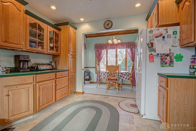 kitchen featuring an inviting chandelier and white fridge