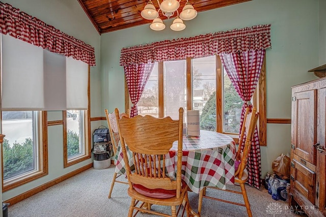 dining area featuring lofted ceiling, a notable chandelier, wooden ceiling, and carpet flooring