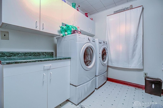 laundry area with cabinets and washing machine and clothes dryer