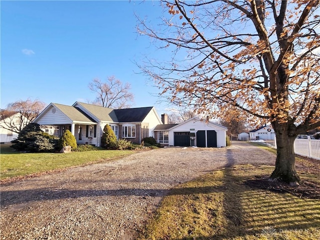 single story home with a garage, an outdoor structure, and a front yard