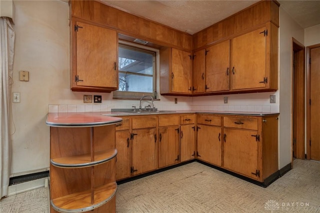 kitchen featuring sink and a textured ceiling