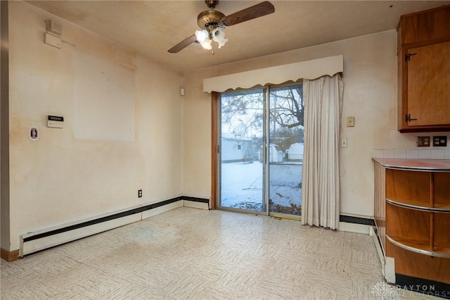 unfurnished dining area with baseboard heating and ceiling fan