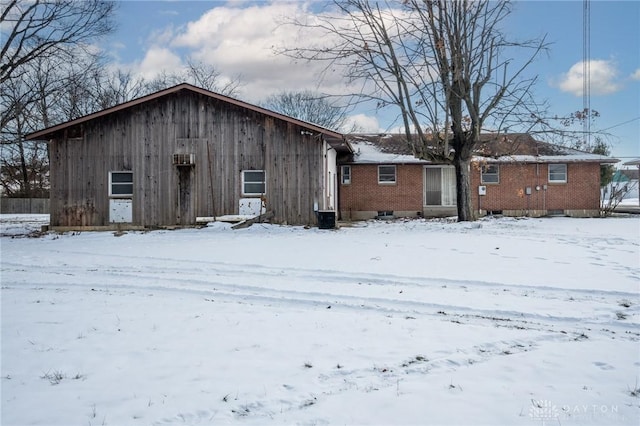 view of snow covered rear of property