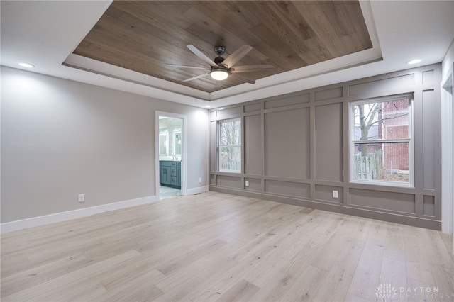 411 E Social Row Rd, Washington Twp, OH 45458 - unfurnished room with a ceiling fan, a raised ceiling, baseboards, a decorative wall, and light wood-style flooring