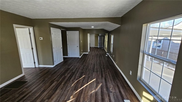 hall with dark hardwood / wood-style floors and a textured ceiling