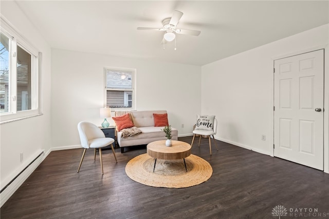 living area featuring a baseboard radiator, dark hardwood / wood-style floors, and ceiling fan