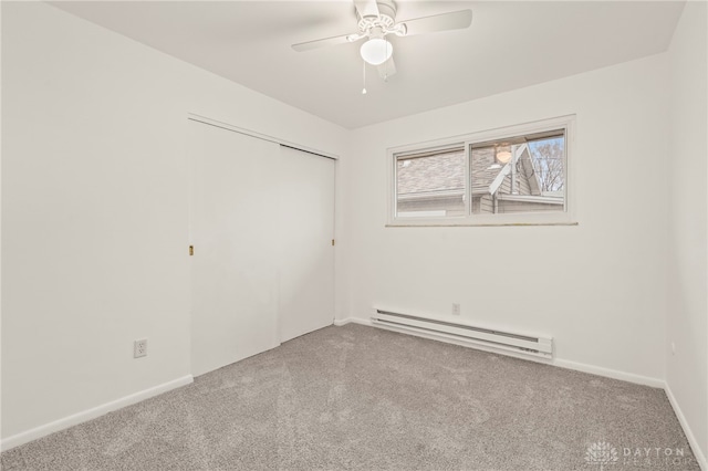 carpeted spare room featuring ceiling fan and a baseboard radiator