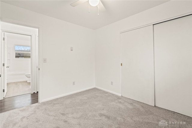 unfurnished bedroom with carpet floors, a closet, and ceiling fan