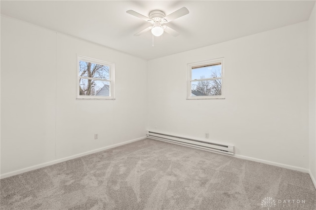 empty room with a baseboard heating unit, light carpet, and ceiling fan