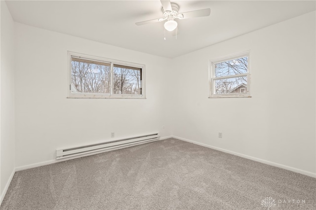 spare room featuring carpet floors, a baseboard heating unit, and ceiling fan