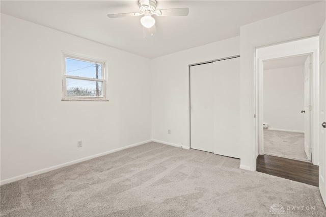 unfurnished bedroom with light carpet, a closet, and ceiling fan