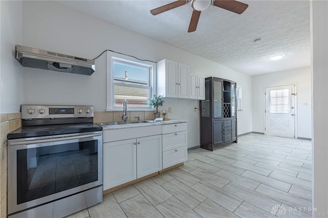 kitchen with white cabinetry, sink, a textured ceiling, and electric range